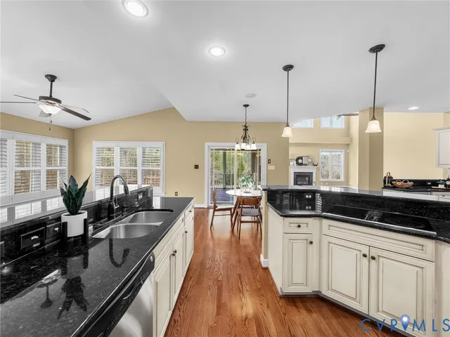 a kitchen with stainless steel appliances a sink stove and cabinets
