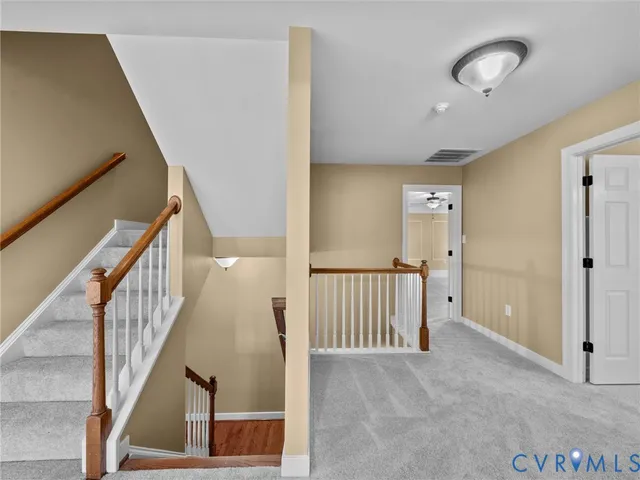 a front view of a house with garden and trees