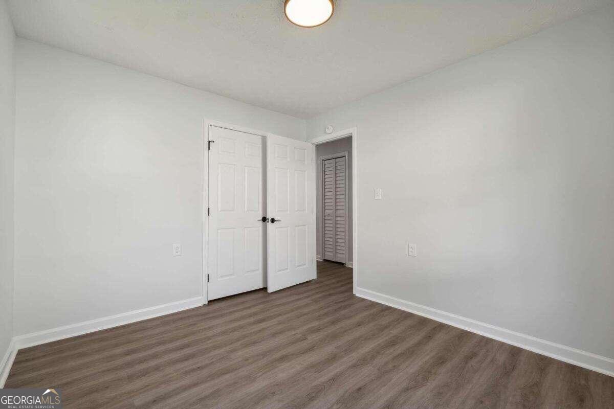823 Humphries Street Southwest Atlanta, GA 30310 - Photo 18 of 22 a view of an empty room with wooden floor