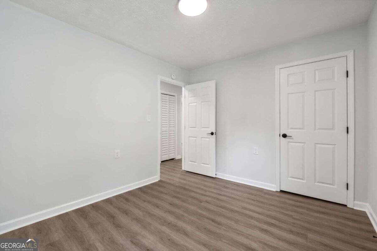 823 Humphries Street Southwest Atlanta, GA 30310 - Photo 19 of 22 a view of an empty room with wooden floor
