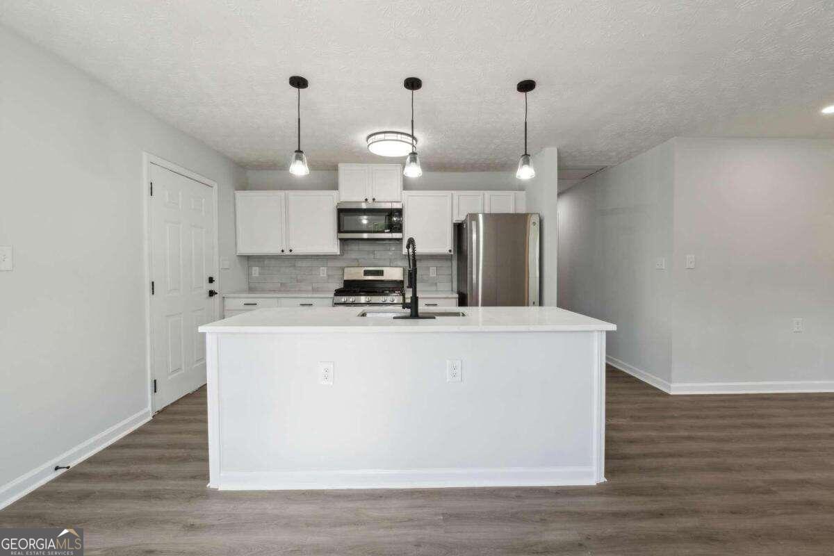 823 Humphries Street Southwest Atlanta, GA 30310 - Photo 4 of 22 a view of kitchen center island and wooden floor