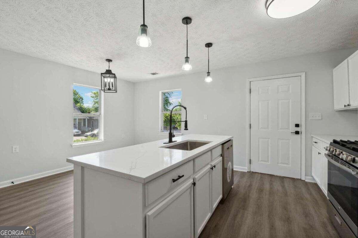 823 Humphries Street Southwest Atlanta, GA 30310 - Photo 7 of 22 a spacious bathroom with a granite countertop sink a mirror and a bathtub