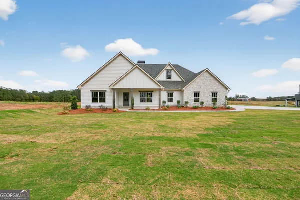 a view of house that has a big yard