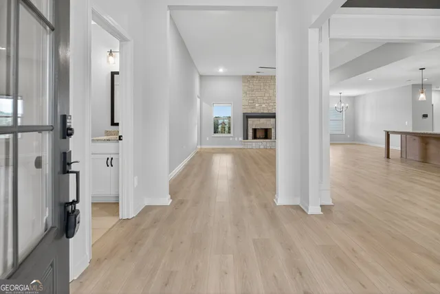 a view of a hallway with wooden floor and staircase