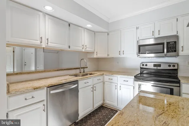 a view of a kitchen with wooden floor and a ceiling fan