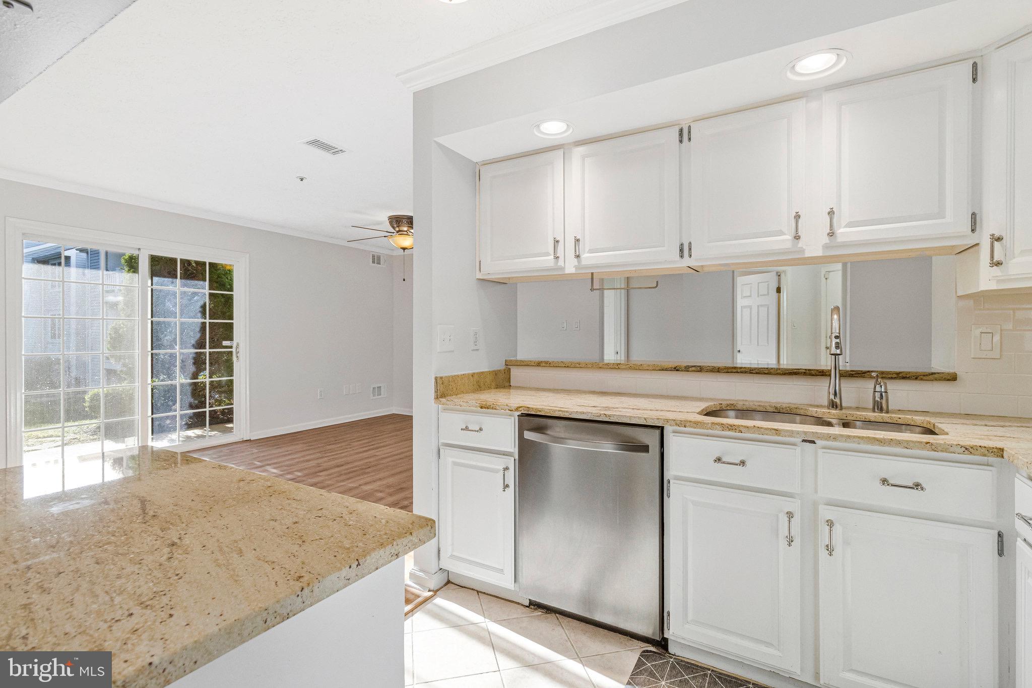 12212 Eagles Nest Court, Unit B Germantown, MD 20874 - Photo 15 of 36 a kitchen with a sink stove and cabinets
