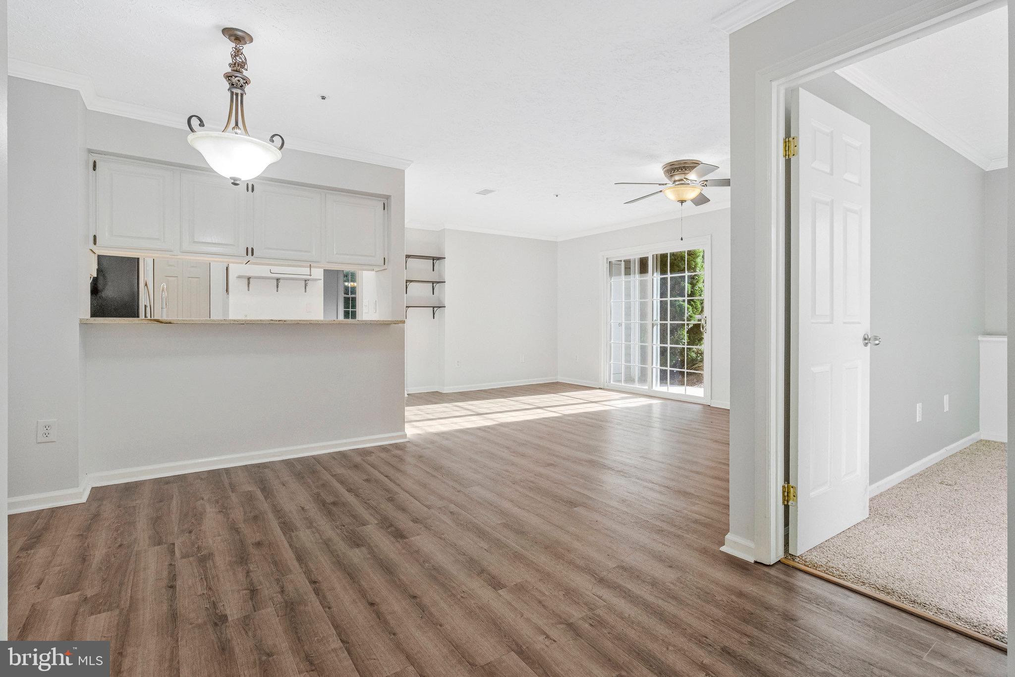 12212 Eagles Nest Court, Unit B Germantown, MD 20874 - Photo 16 of 36 a view of a kitchen with wooden floor and a ceiling fan