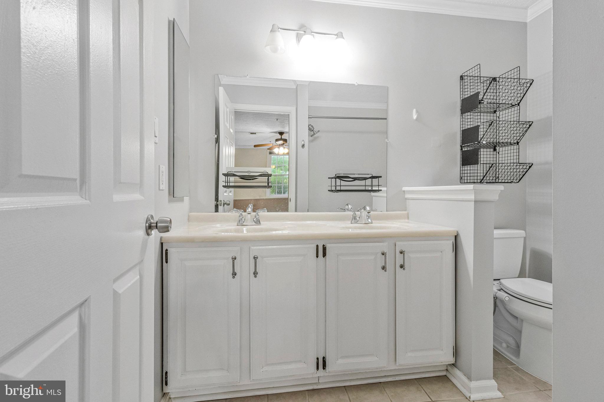 12212 Eagles Nest Court, Unit B Germantown, MD 20874 - Photo 18 of 36 a bathroom with a double vanity sink and a toilet