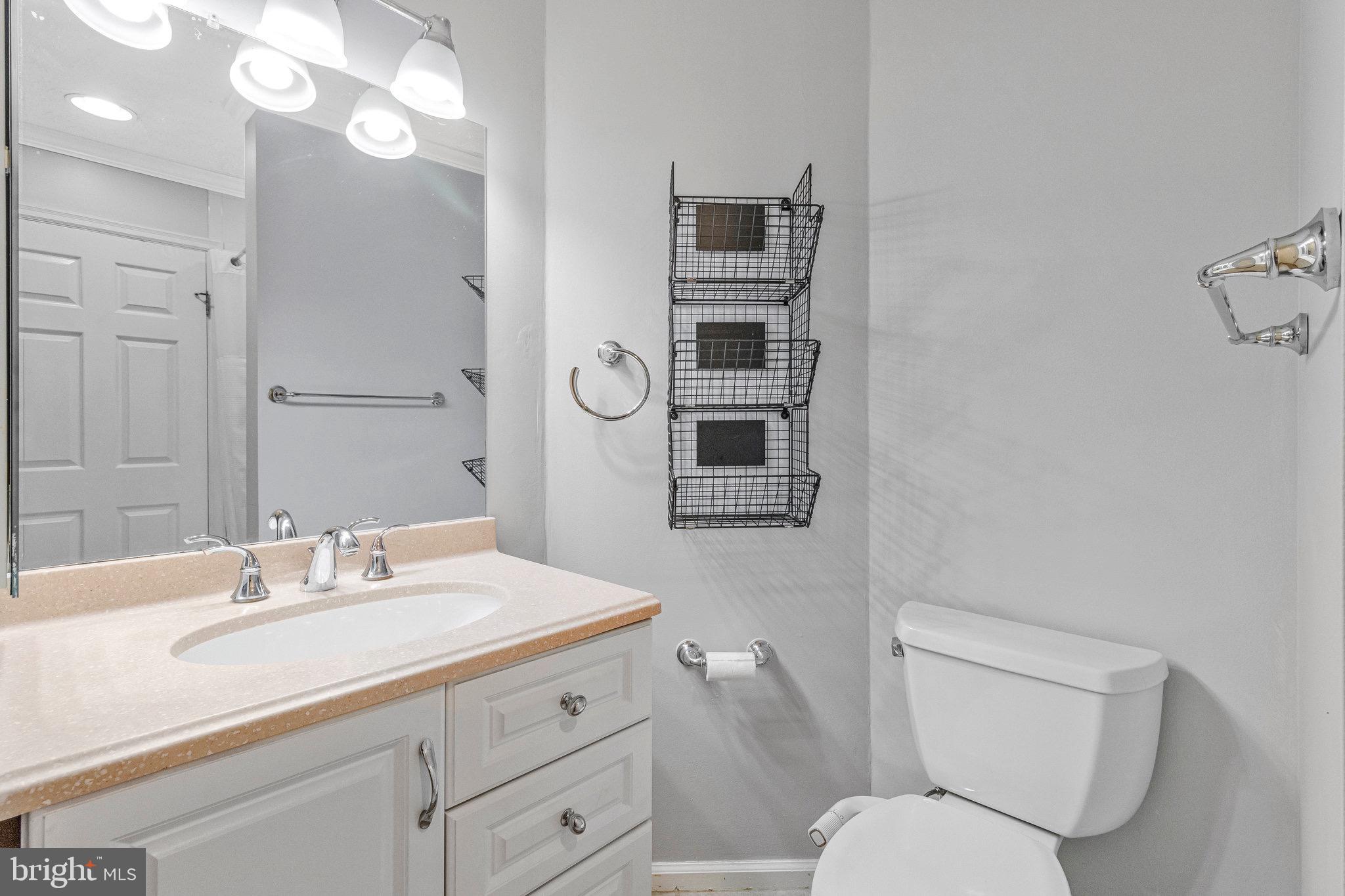 12212 Eagles Nest Court, Unit B Germantown, MD 20874 - Photo 21 of 36 a bathroom with a toilet sink and mirror