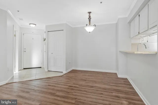 a view of a kitchen with wooden floor and a ceiling fan