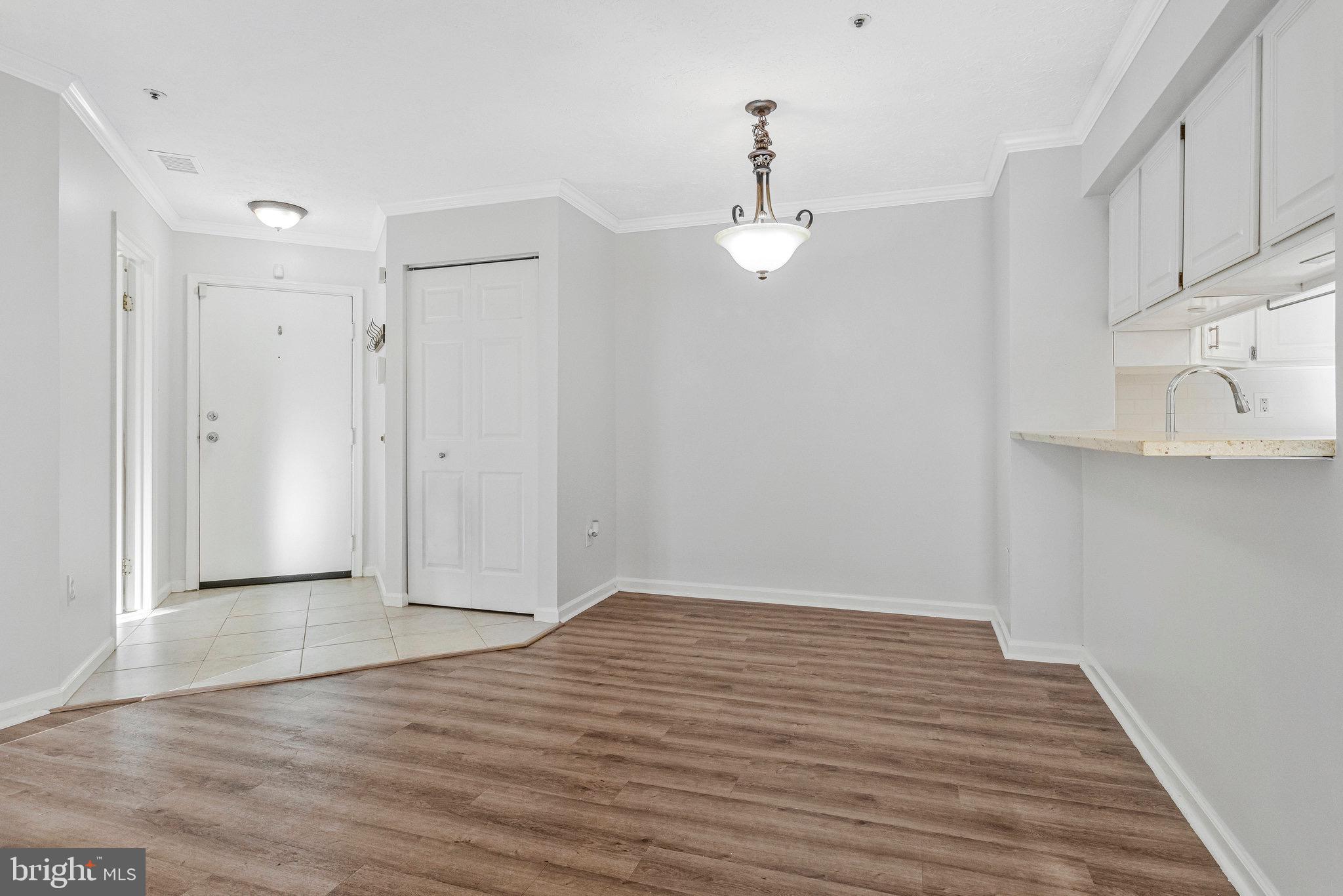 12212 Eagles Nest Court, Unit B Germantown, MD 20874 - Photo 23 of 36 a view of an empty room with wooden floor and a window