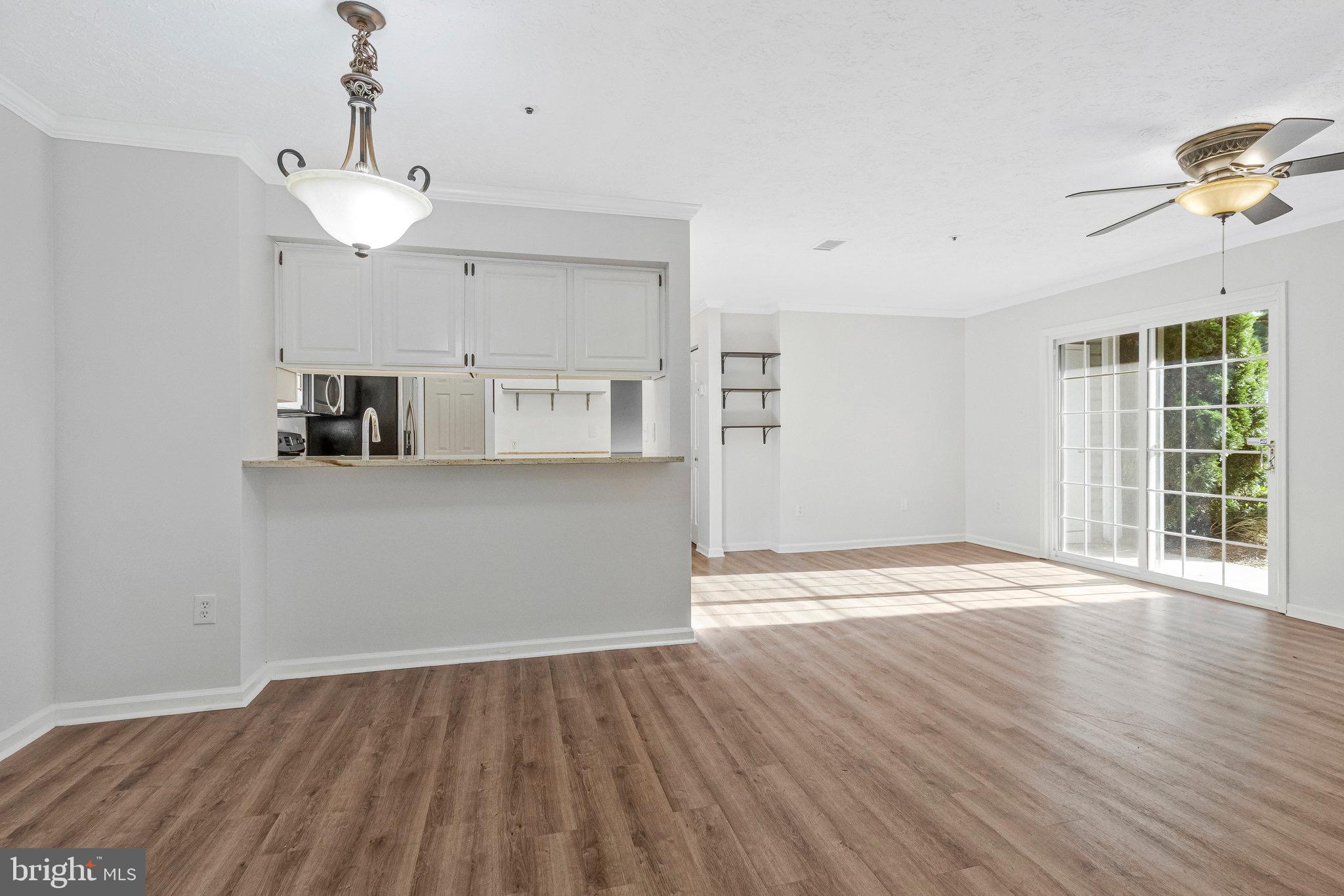 12212 Eagles Nest Court, Unit B Germantown, MD 20874 - Photo 25 of 36 a view of a kitchen with wooden floor and a ceiling fan
