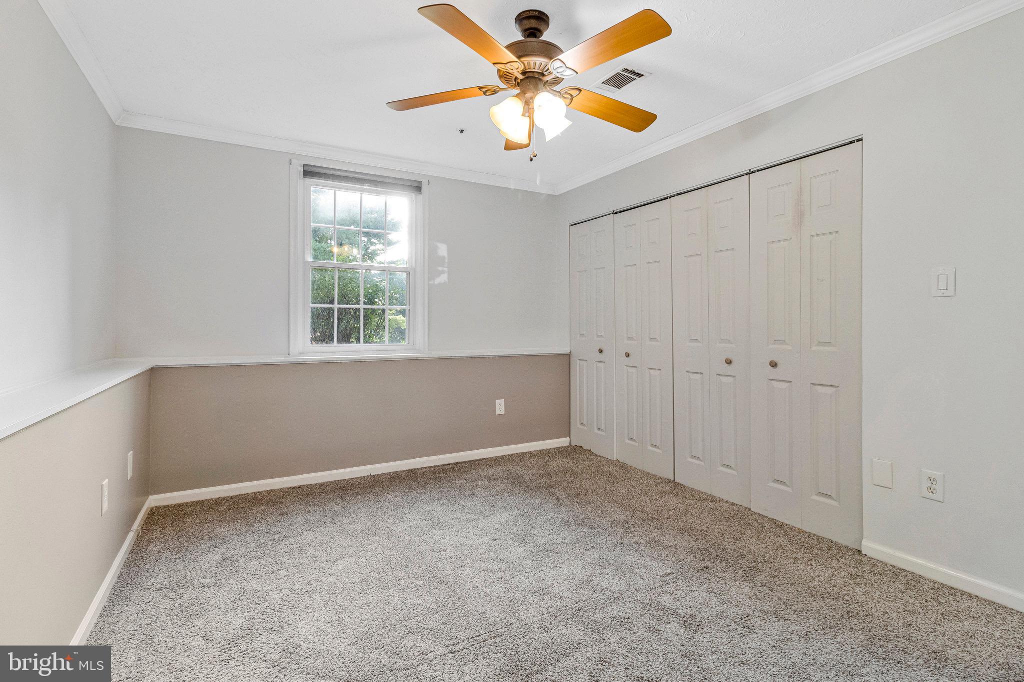 12212 Eagles Nest Court, Unit B Germantown, MD 20874 - Photo 28 of 36 an empty room with a window and a fan