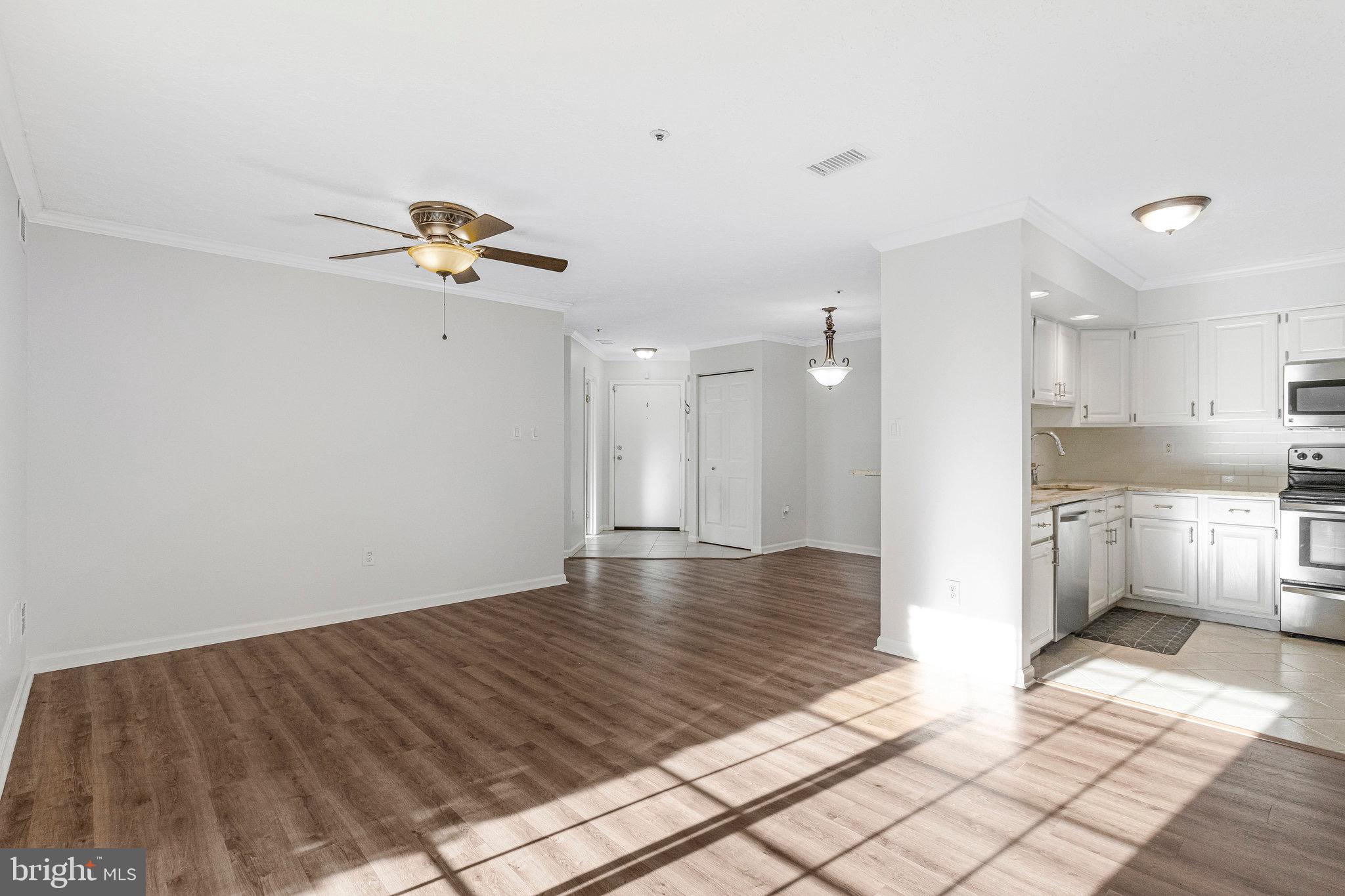 12212 Eagles Nest Court, Unit B Germantown, MD 20874 - Photo 31 of 36 a view of kitchen with stainless steel appliances kitchen island granite countertop a refrigerator and a sink
