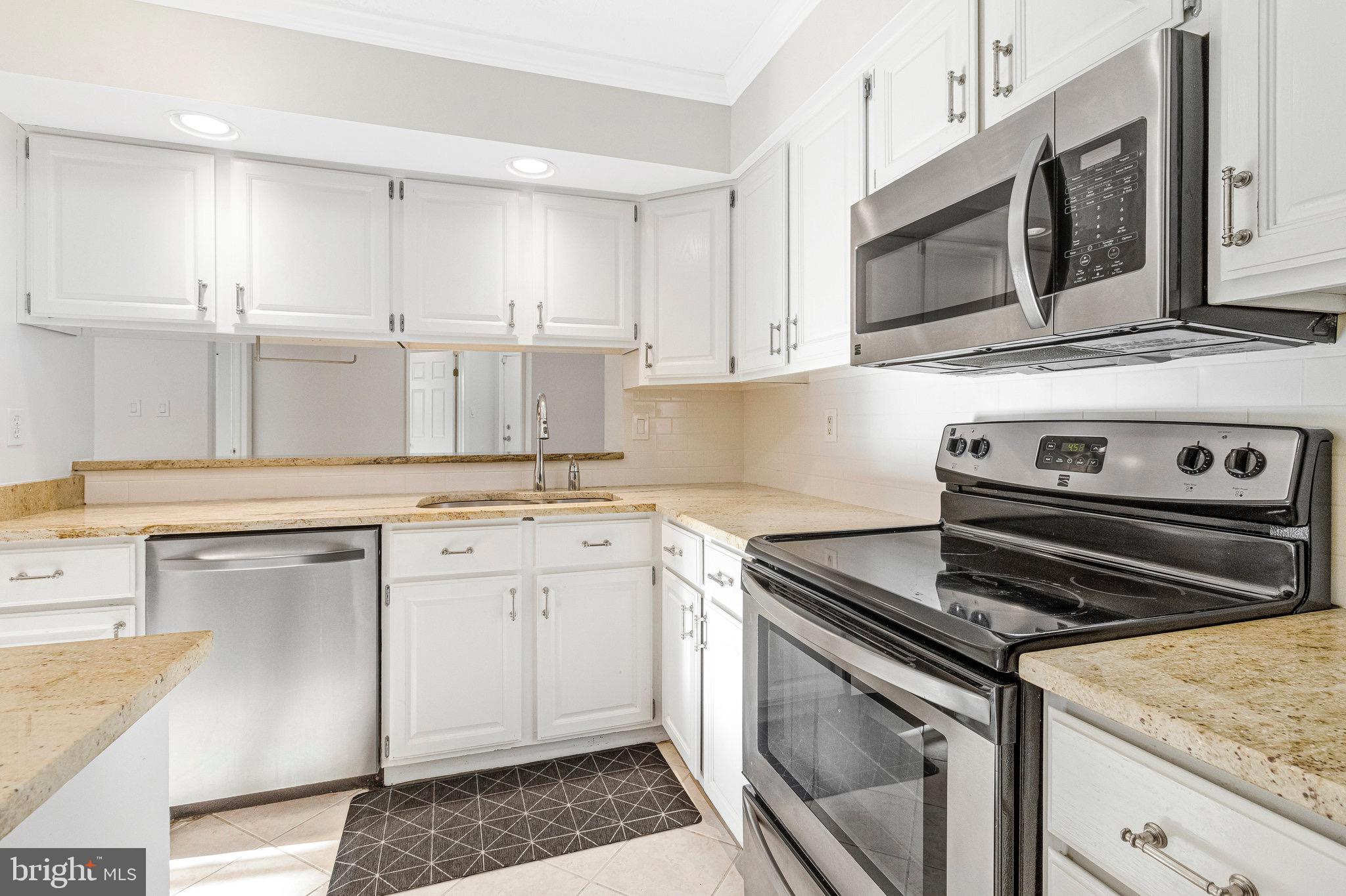 12212 Eagles Nest Court, Unit B Germantown, MD 20874 - Photo 36 of 36 a kitchen with appliances cabinets and a sink