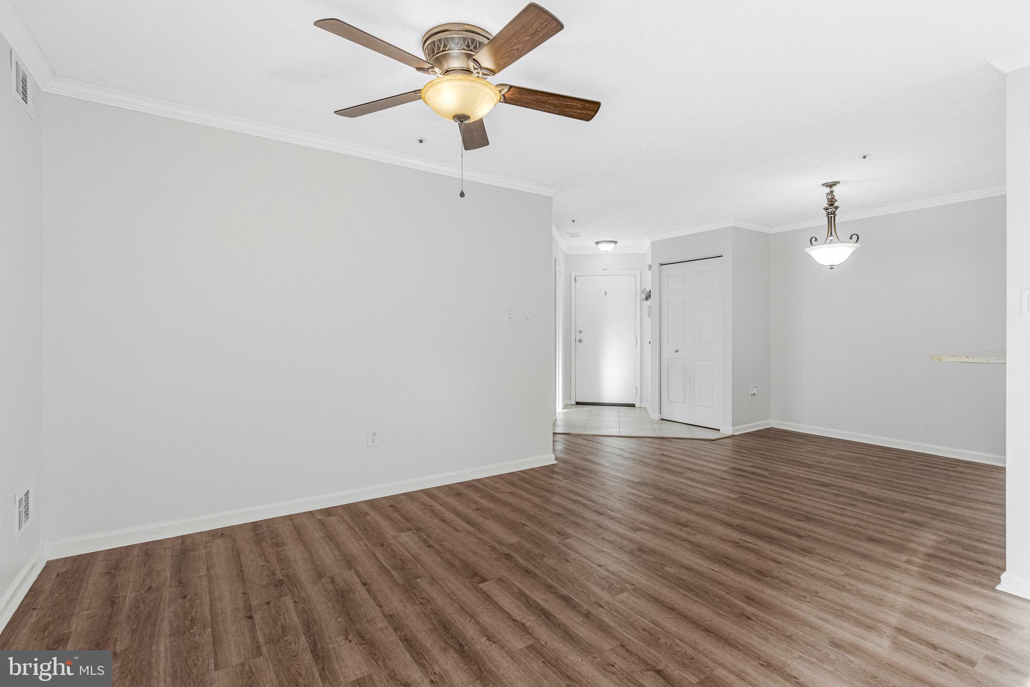 12212 Eagles Nest Court, Unit B Germantown, MD 20874 - Photo 5 of 36 an empty room with wooden floor and a ceiling fan