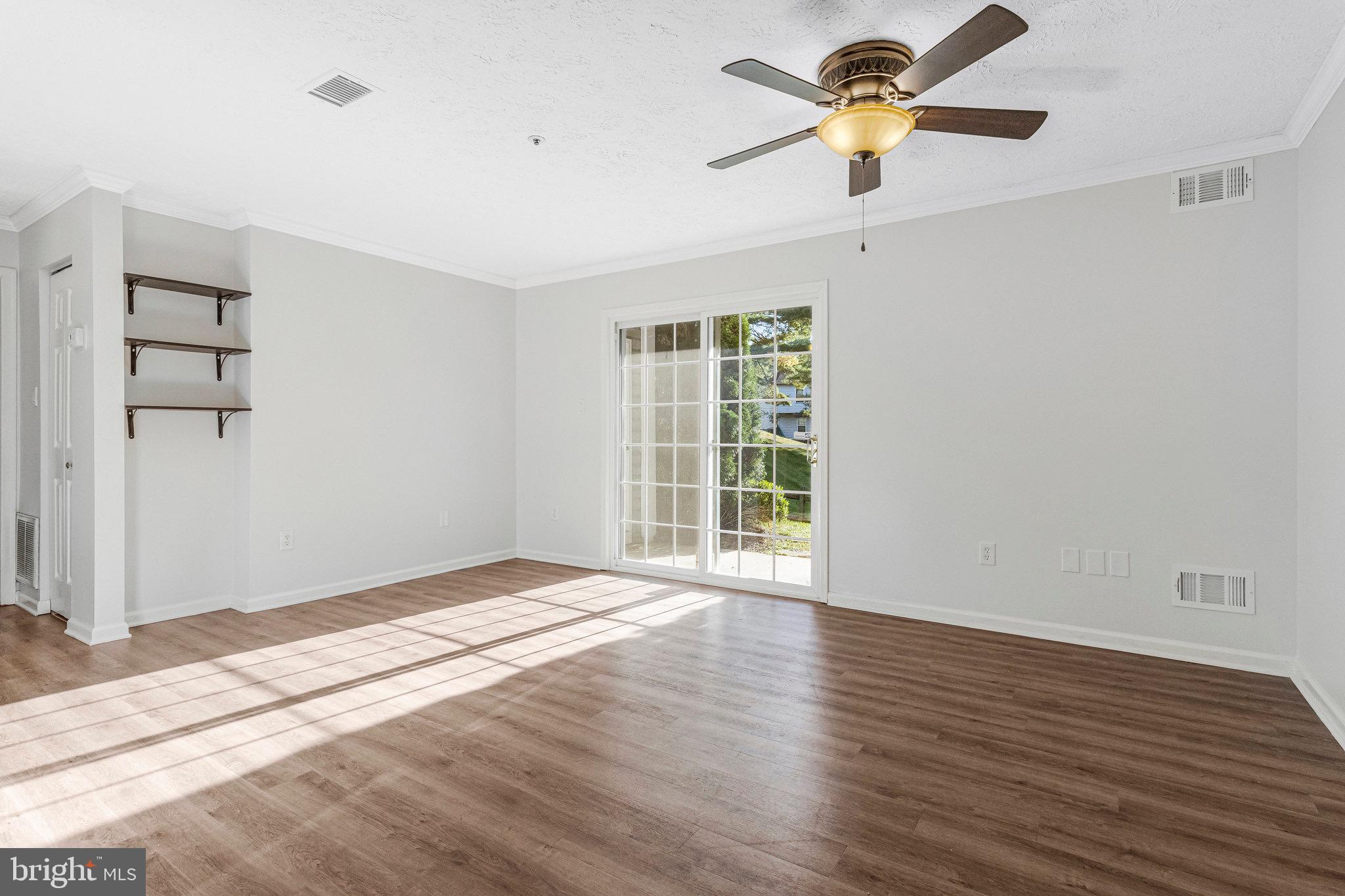 12212 Eagles Nest Court, Unit B Germantown, MD 20874 - Photo 8 of 36 a view of empty room with wooden floor and fan