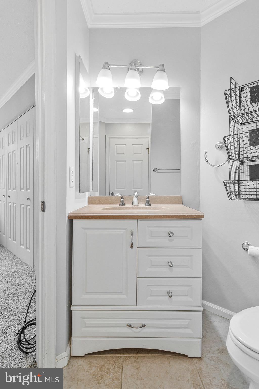 12212 Eagles Nest Court, Unit B Germantown, MD 20874 - Photo 10 of 36 a bathroom with a sink a toilet and a mirror