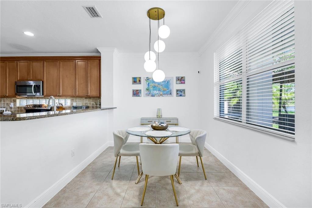 1570 Double Eagle Trail Naples, FL 34120 - Photo 14 of 50 a dining room with furniture and window