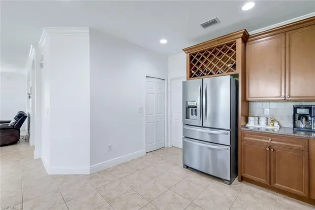 a kitchen with stainless steel appliances a refrigerator and cabinets