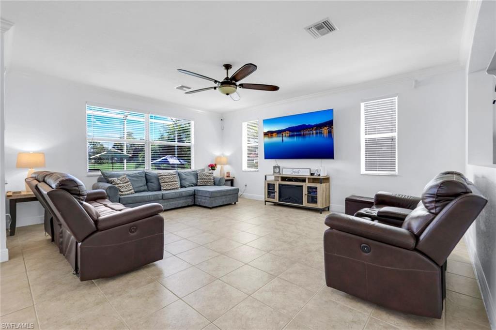 1570 Double Eagle Trail Naples, FL 34120 - Photo 18 of 50 a living room with fireplace furniture and a flat screen tv