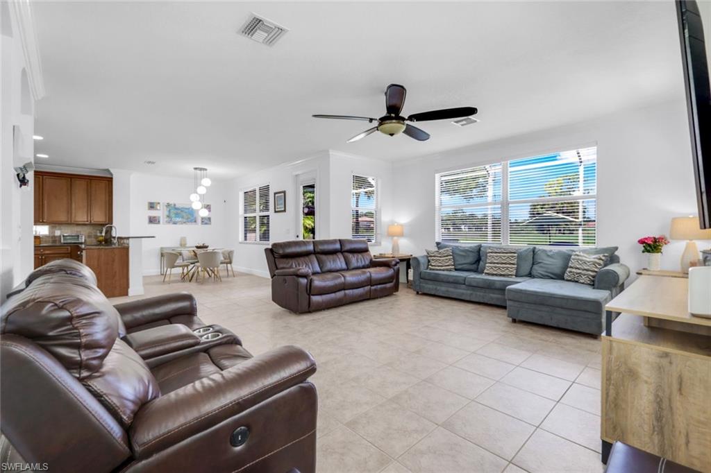 1570 Double Eagle Trail Naples, FL 34120 - Photo 19 of 50 a living room with furniture and a ceiling fan
