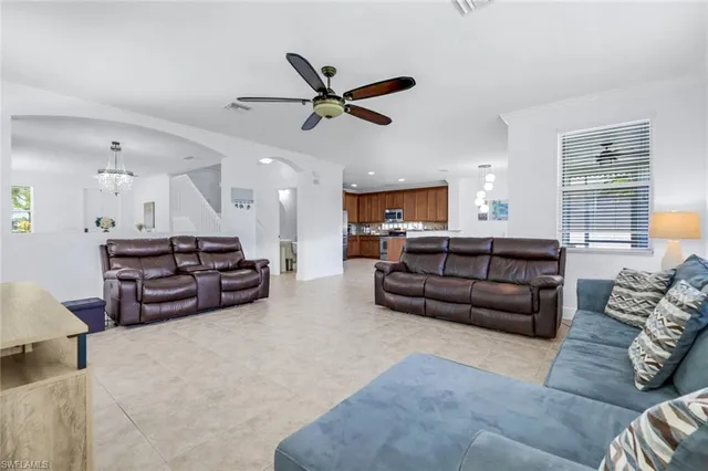 a living room with furniture and kitchen view