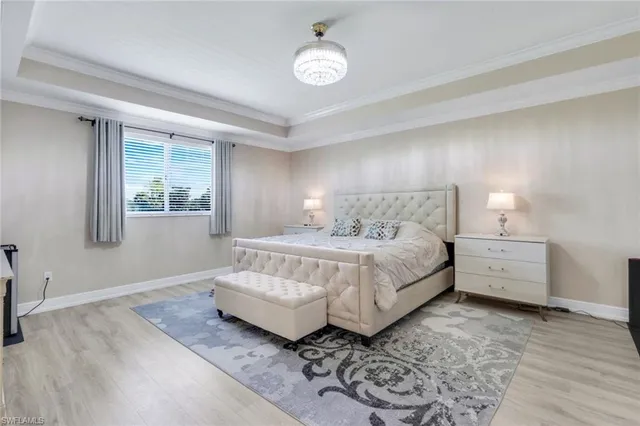 a spacious bedroom with a bed and a window