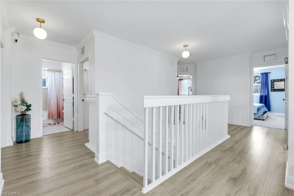 1570 Double Eagle Trail Naples, FL 34120 - Photo 27 of 50 a view of a hallway view with wooden floor and staircase