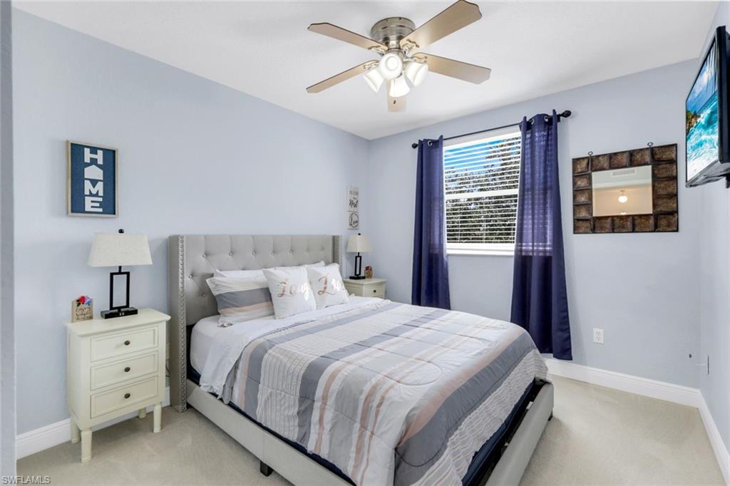 1570 Double Eagle Trail Naples, FL 34120 - Photo 28 of 50 a bedroom with a bed dresser and a window