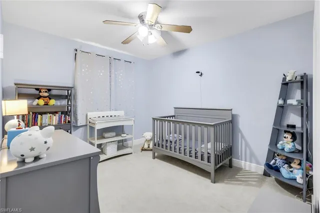 a bedroom with furniture and a baby crib