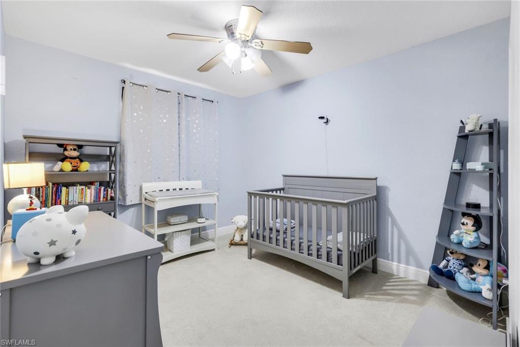 1570 Double Eagle Trail Naples, FL 34120 - Photo 30 of 50 a bedroom with furniture and a baby crib