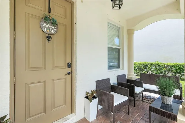a view of a hallway with dining room and wooden door