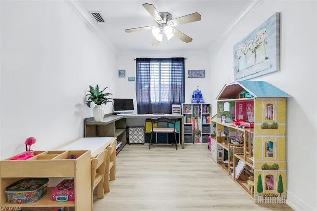 a living room with furniture cabinets and a window