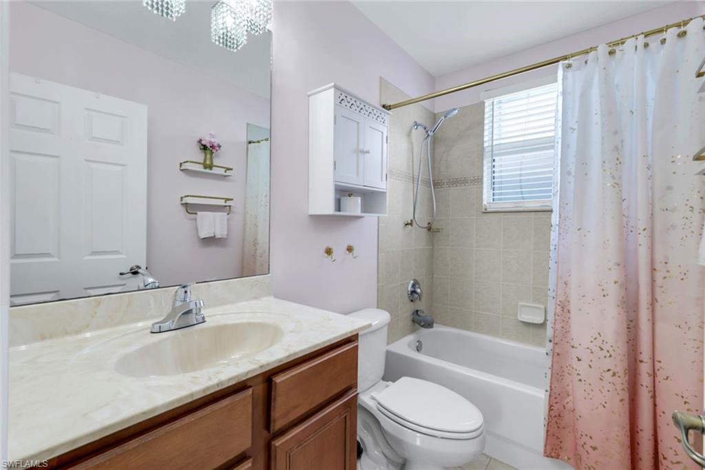 1570 Double Eagle Trail Naples, FL 34120 - Photo 34 of 50 a bathroom with a granite countertop bathtub shower sink vanity mirror and toilet