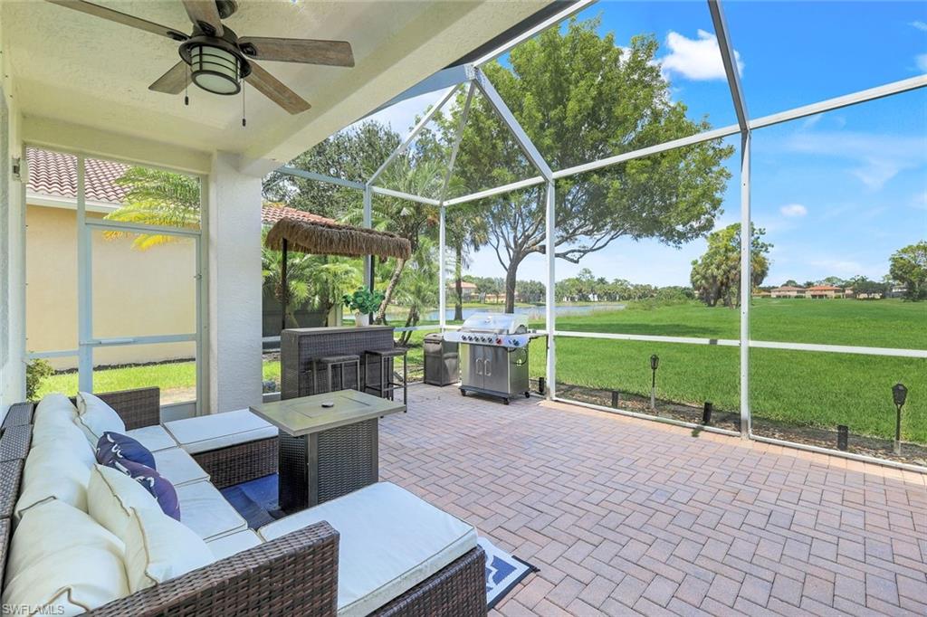 1570 Double Eagle Trail Naples, FL 34120 - Photo 36 of 50 a house view with a seating space and a ocean view in the background