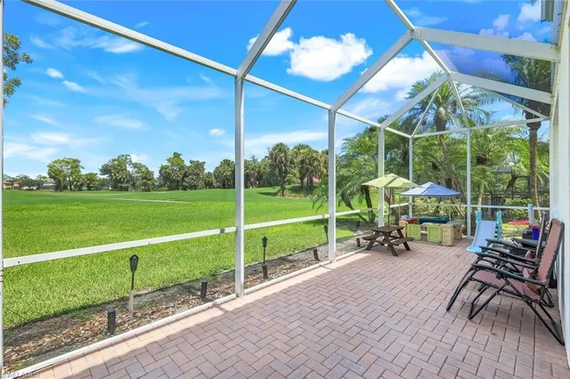 a view of a table and chairs in patio with a yard