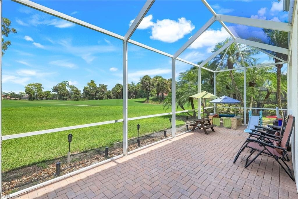 1570 Double Eagle Trail Naples, FL 34120 - Photo 38 of 50 a view of a table and chairs in patio with a yard