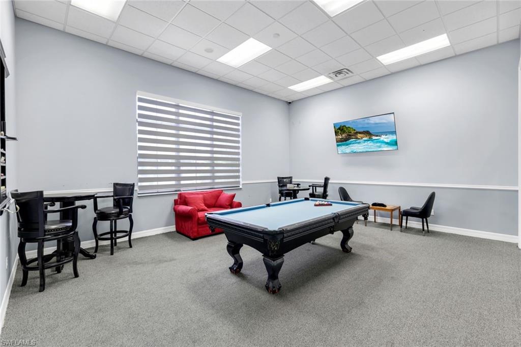 1570 Double Eagle Trail Naples, FL 34120 - Photo 45 of 50 a room with furniture and tables