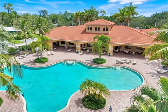 an aerial view of a house with garden space and swimming pool