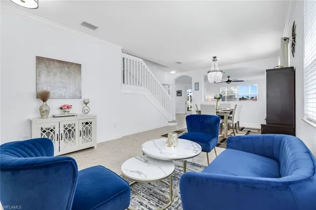 a living room with furniture and kitchen view