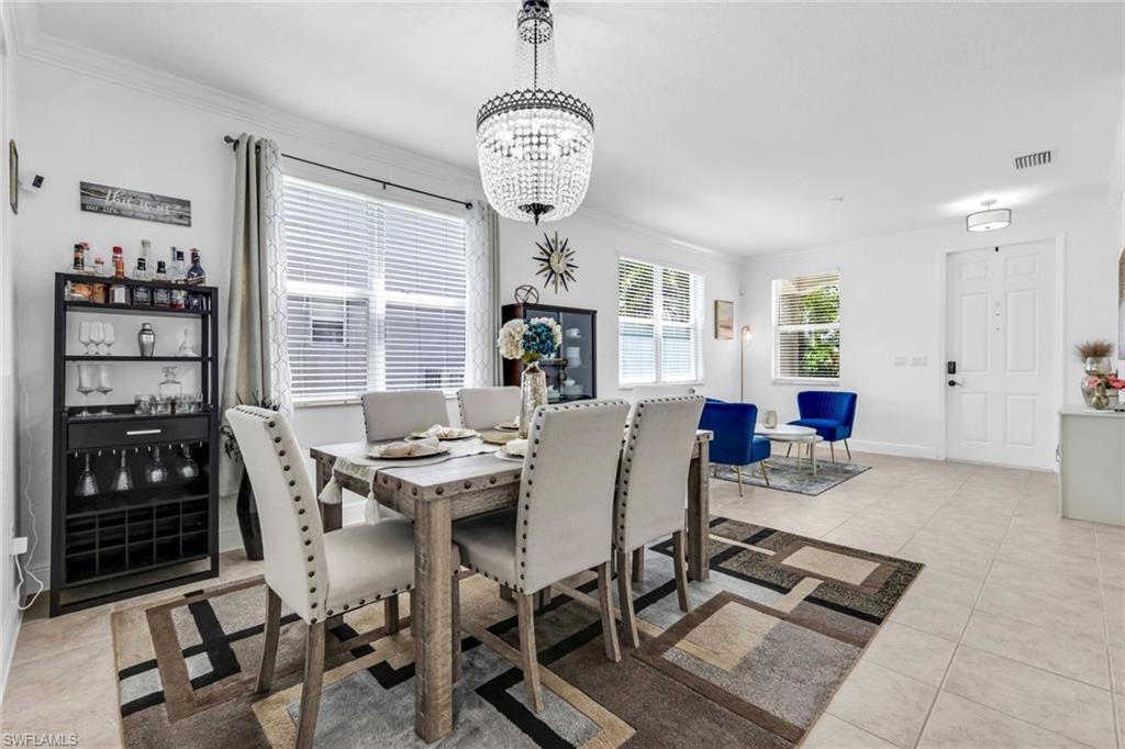 1570 Double Eagle Trail Naples, FL 34120 - Photo 8 of 50 a view of a dining room with furniture window and racks