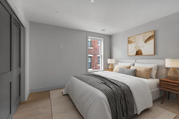 a bedroom with a bed and a window