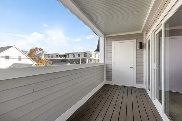 a view of balcony with wooden floor