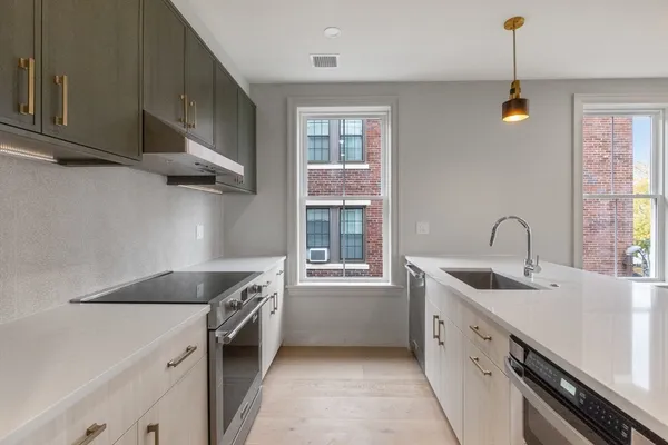 a kitchen that has a sink and a stove