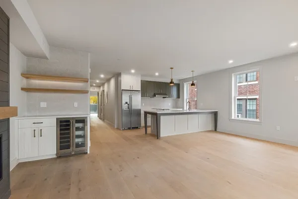 a view of kitchen with kitchen island a sink stainless steel appliances and cabinets
