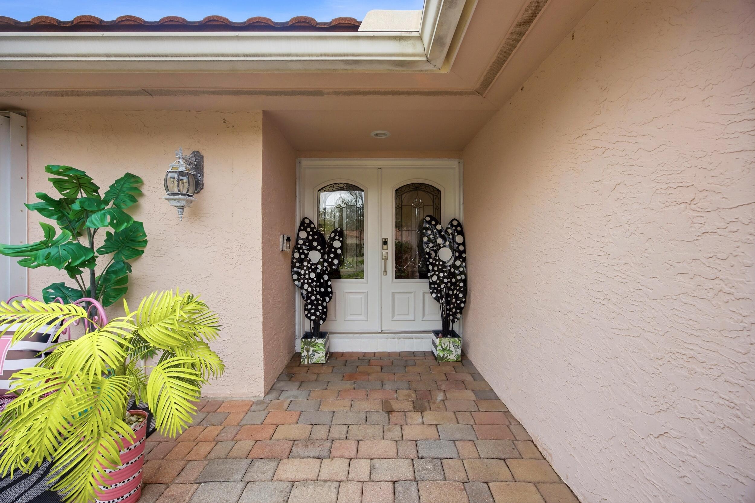 375 Northwest 53rd Street Boca Raton, FL 33487 - Photo 5 of 14 a view of entryway with flower pots