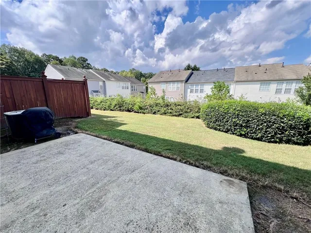 a front view of a house with a yard and a garage