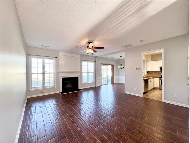 a view of empty room with wooden floor and fireplace