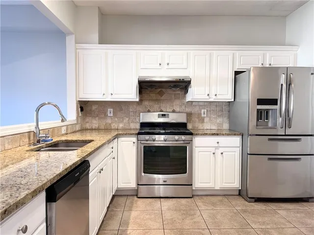 a kitchen with a sink stove and refrigerator